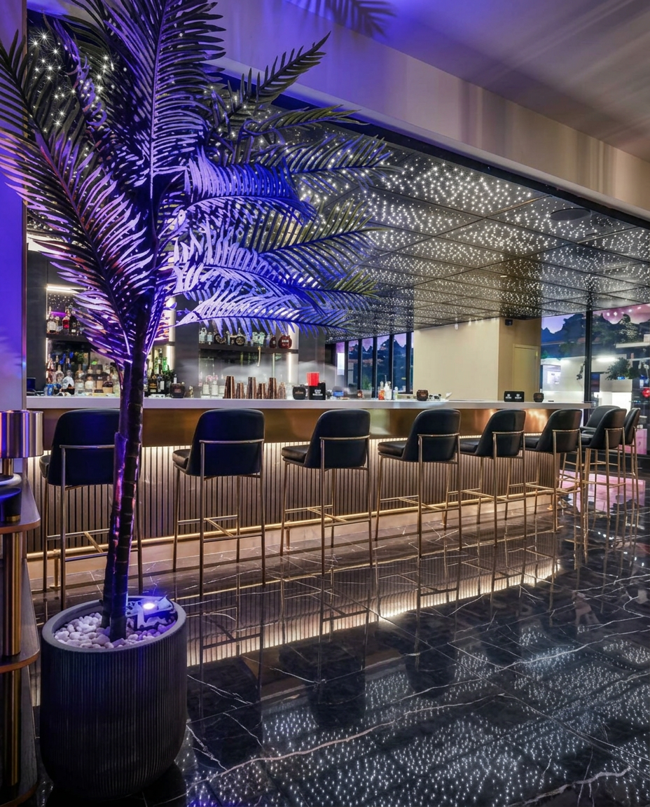 Interior of Zooz DC — illuminated bar with palm and gold accents